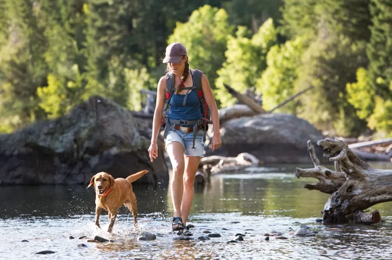 woman hiking with dog