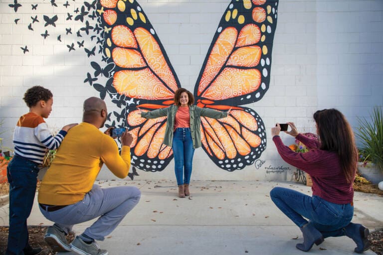 lady at butterfly mural in Sevierville
